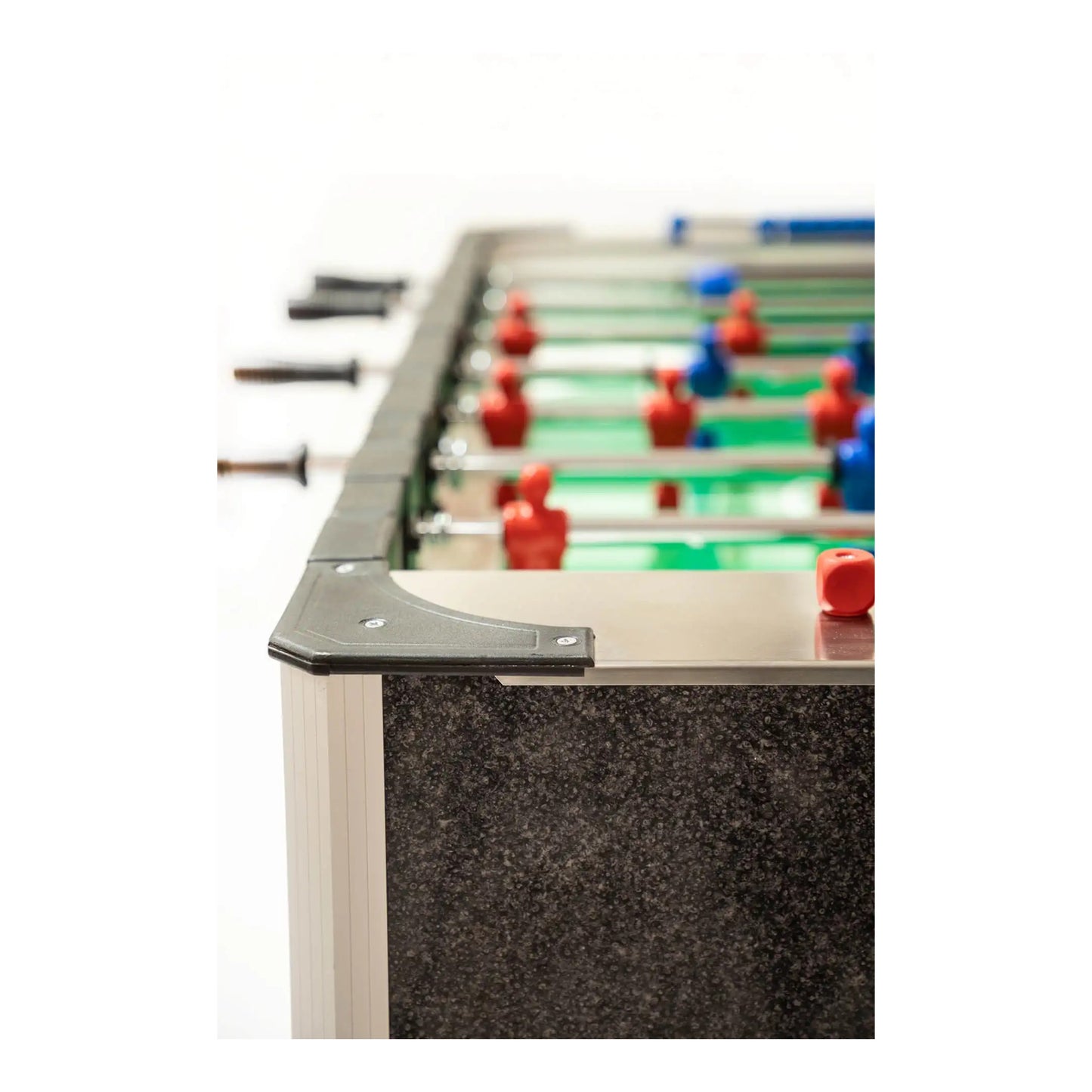 Close-up of a foosball table with red and blue player figures on a white background
