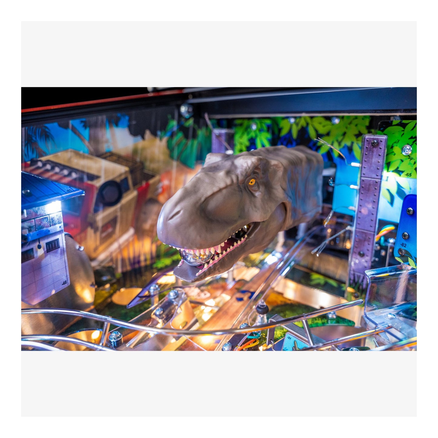 Dinosaur figure on a pinball machine with colorful background