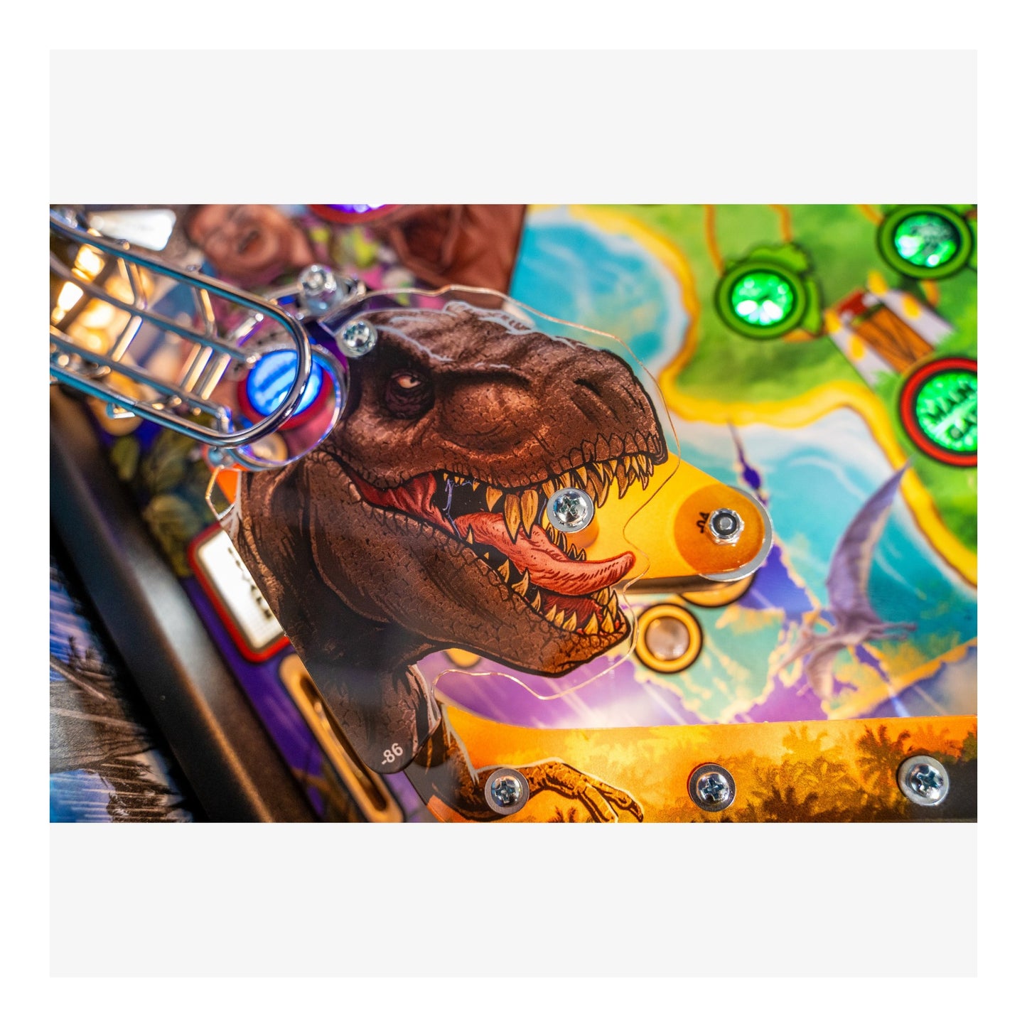 Close-up of a dinosaur figure on a colorful pinball machine