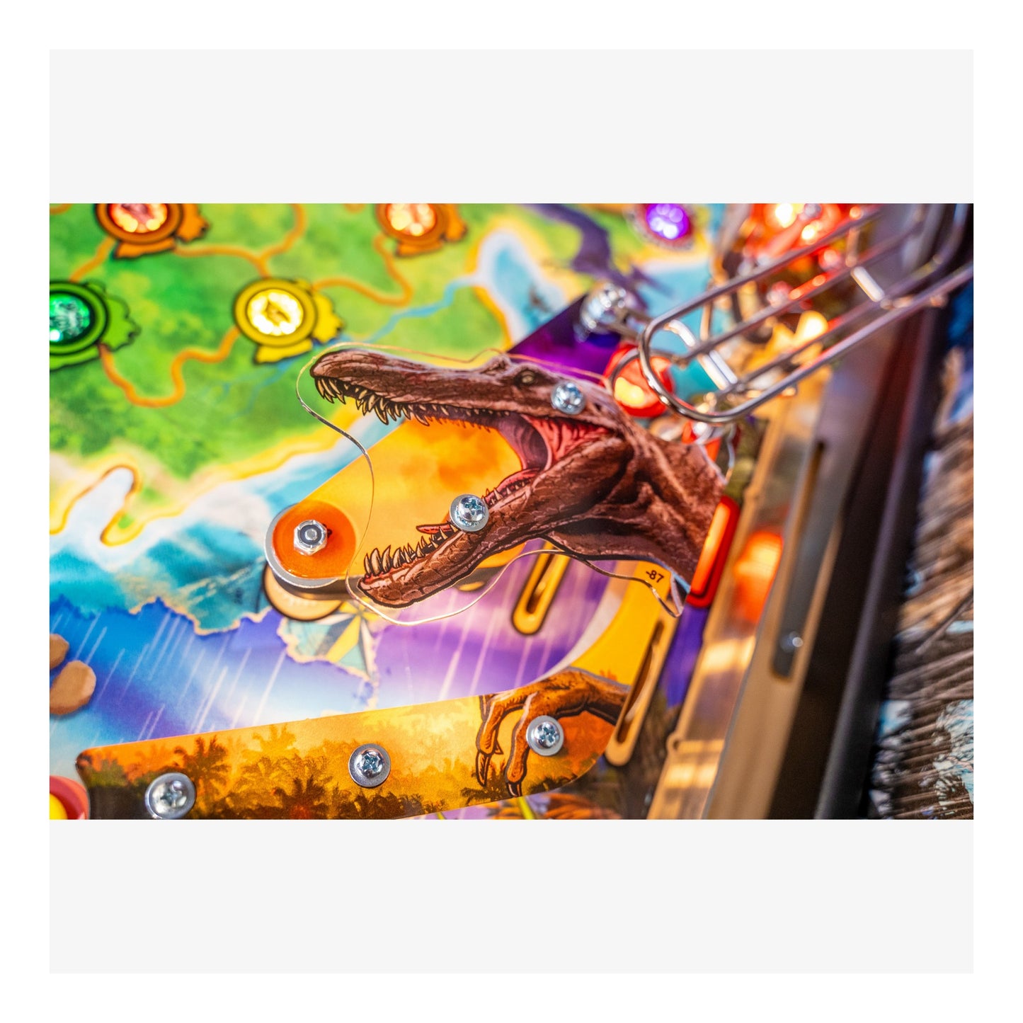 Close-up of a pinball machine with a colorful playfield and a dragon figure.
