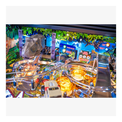 Close-up of a pinball machine with a dinosaur theme