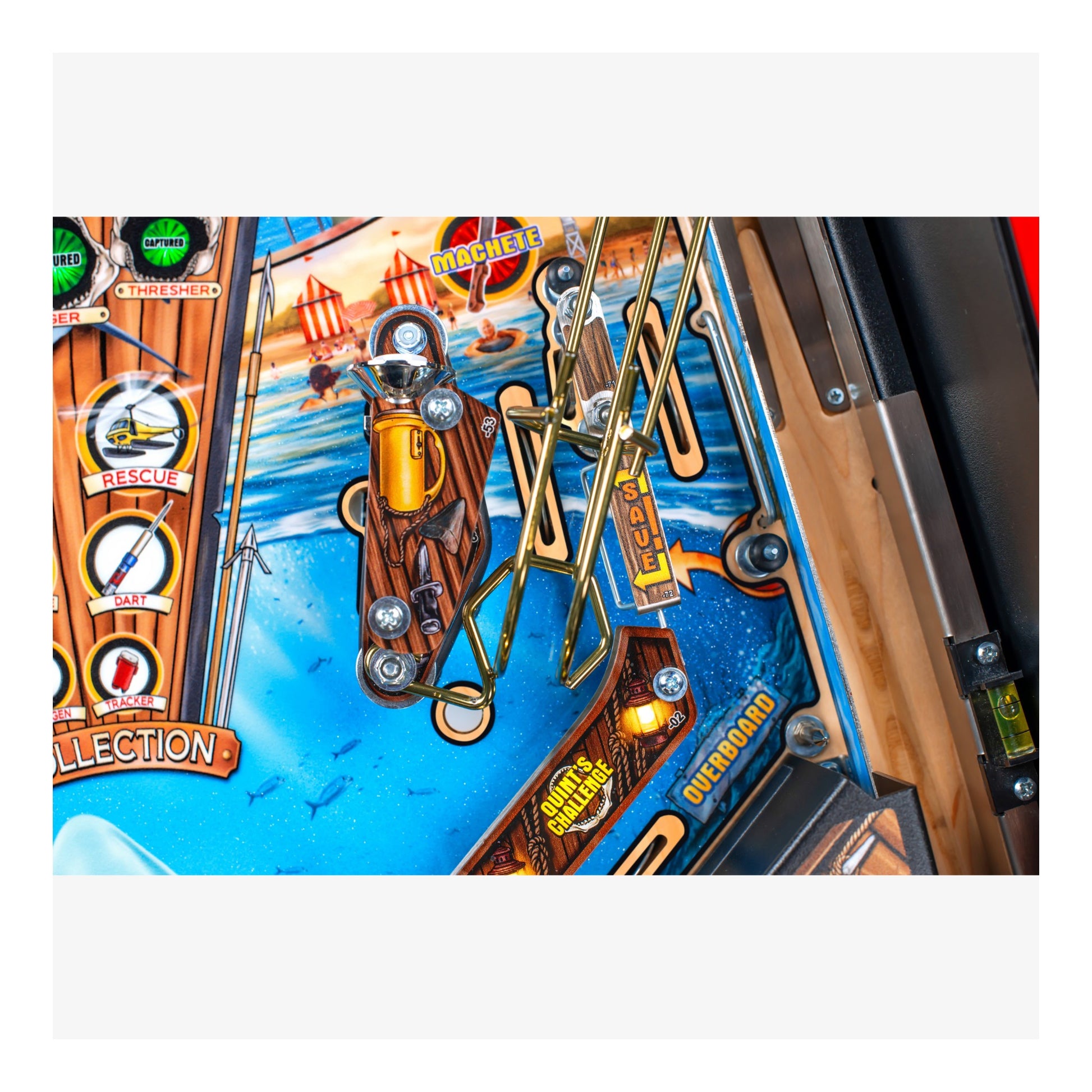 Close-up of a pinball machine with colorful artwork and mechanical components.