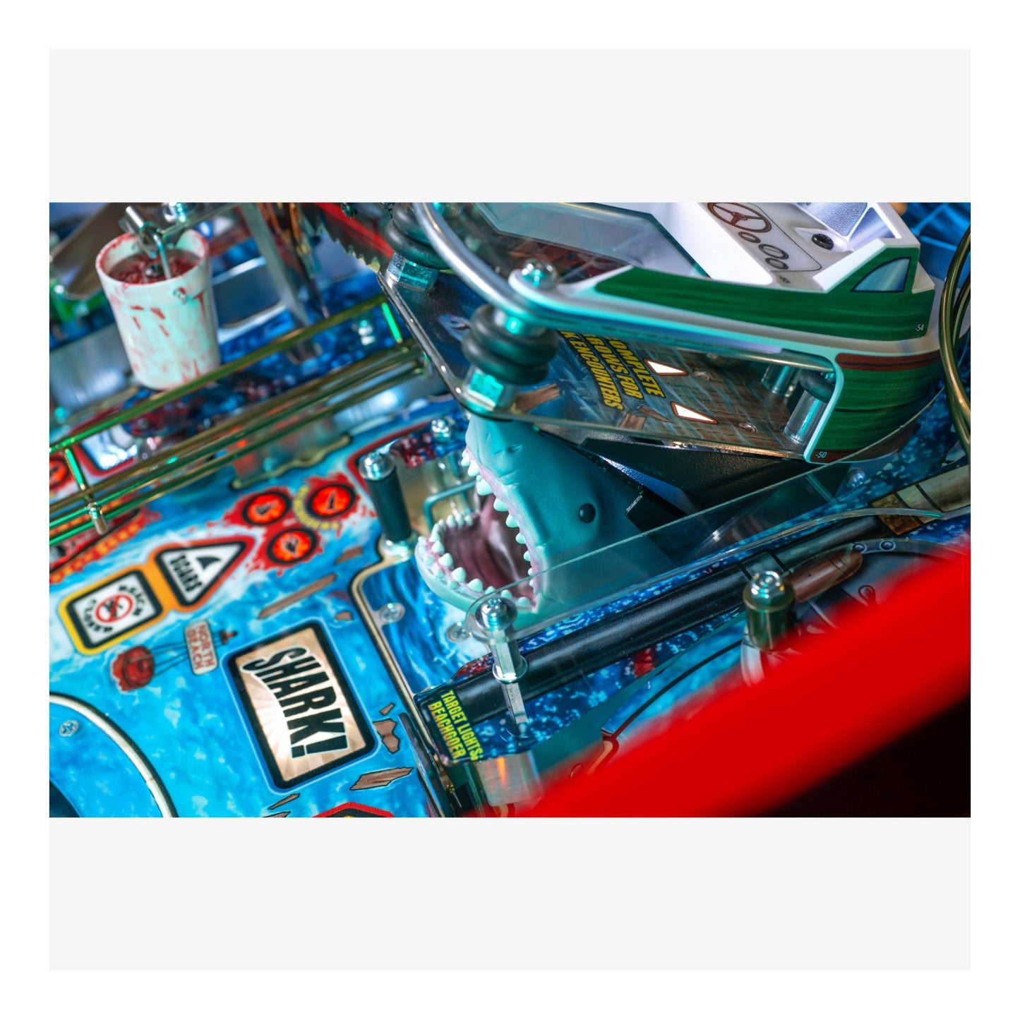 Close-up of a colorful pinball machine with various components.