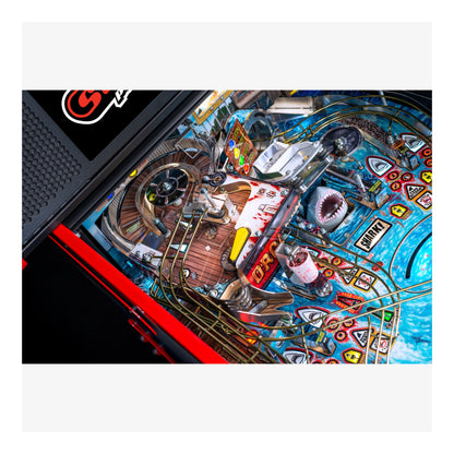 Close-up of a pinball machine with colorful design and various components.