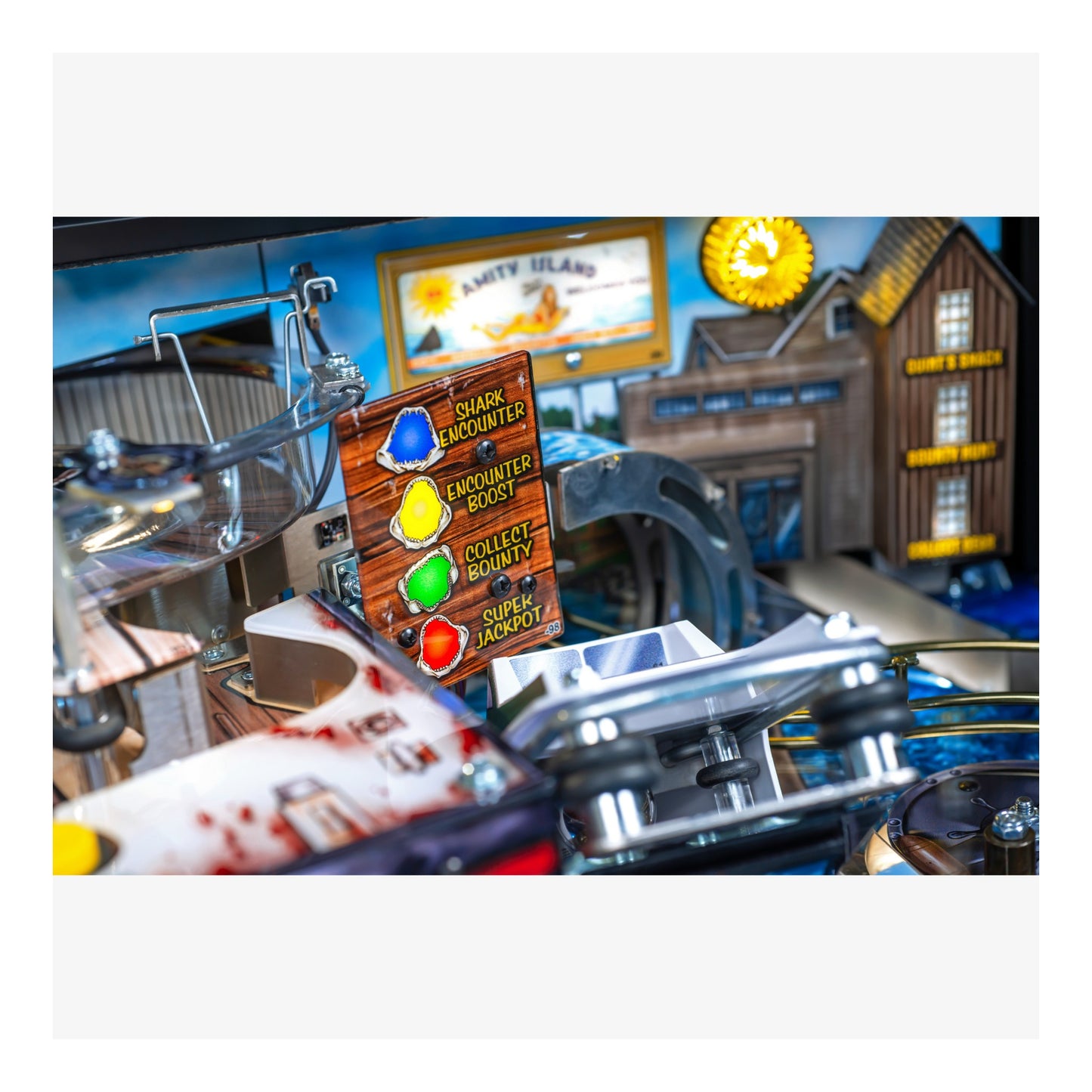 Close-up of a pinball machine with colorful buttons and a detailed background.