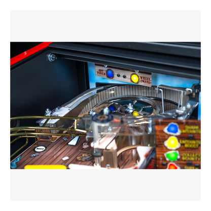 Close-up of a pinball machine with colorful buttons and wooden surface.