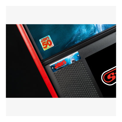 Close-up of a car window with 'Jaws'-themed stickers and a 'G-Force' logo.