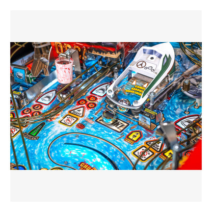 Close-up of a pinball machine with colorful playfield and various components.