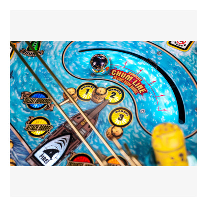 Close-up of a pinball machine with colorful design and text