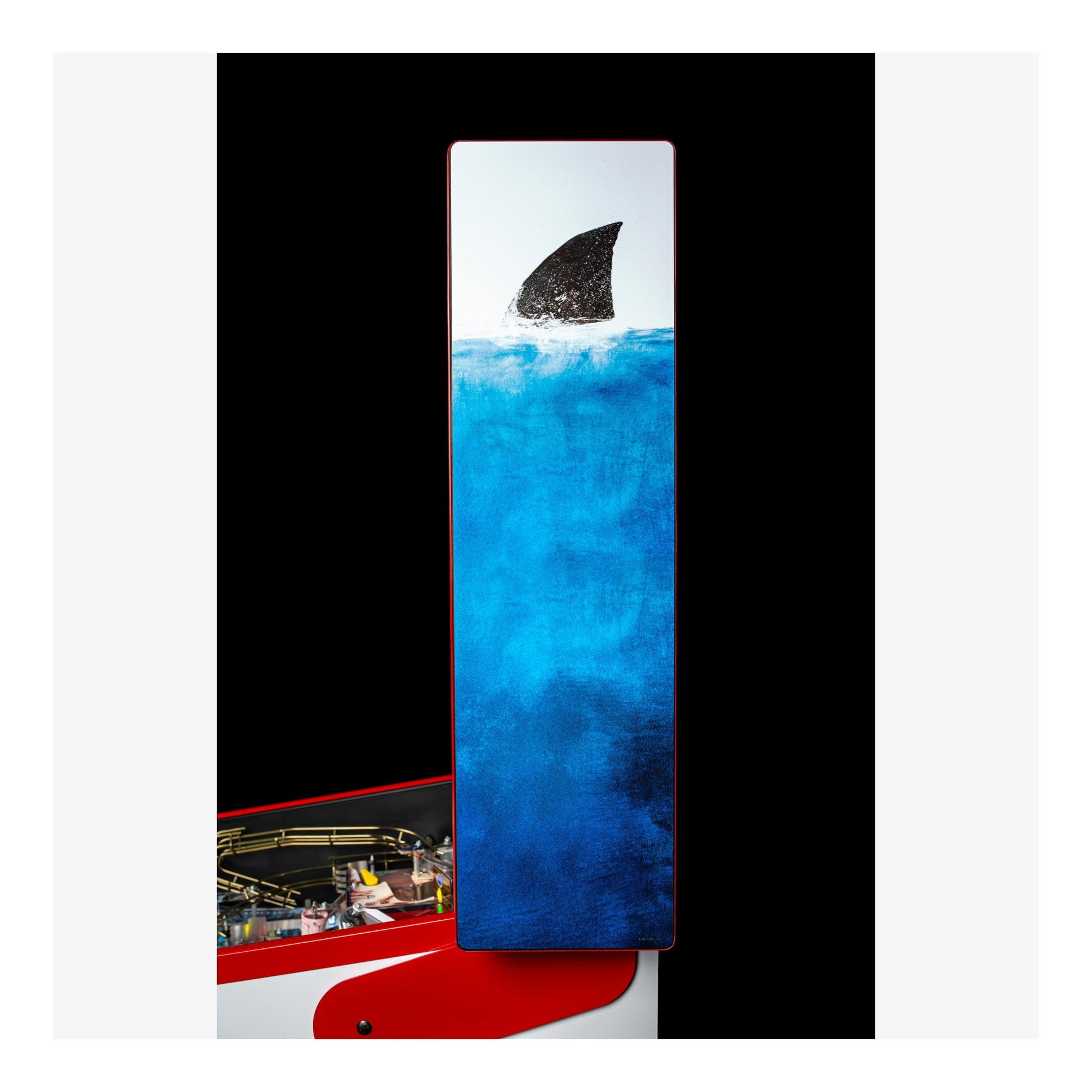 Abstract artwork with a shark fin emerging from blue water, framed by black and white borders.