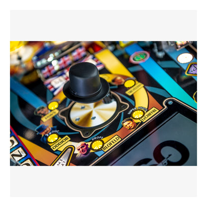 Close-up of a pinball machine with a top hat and colorful design
