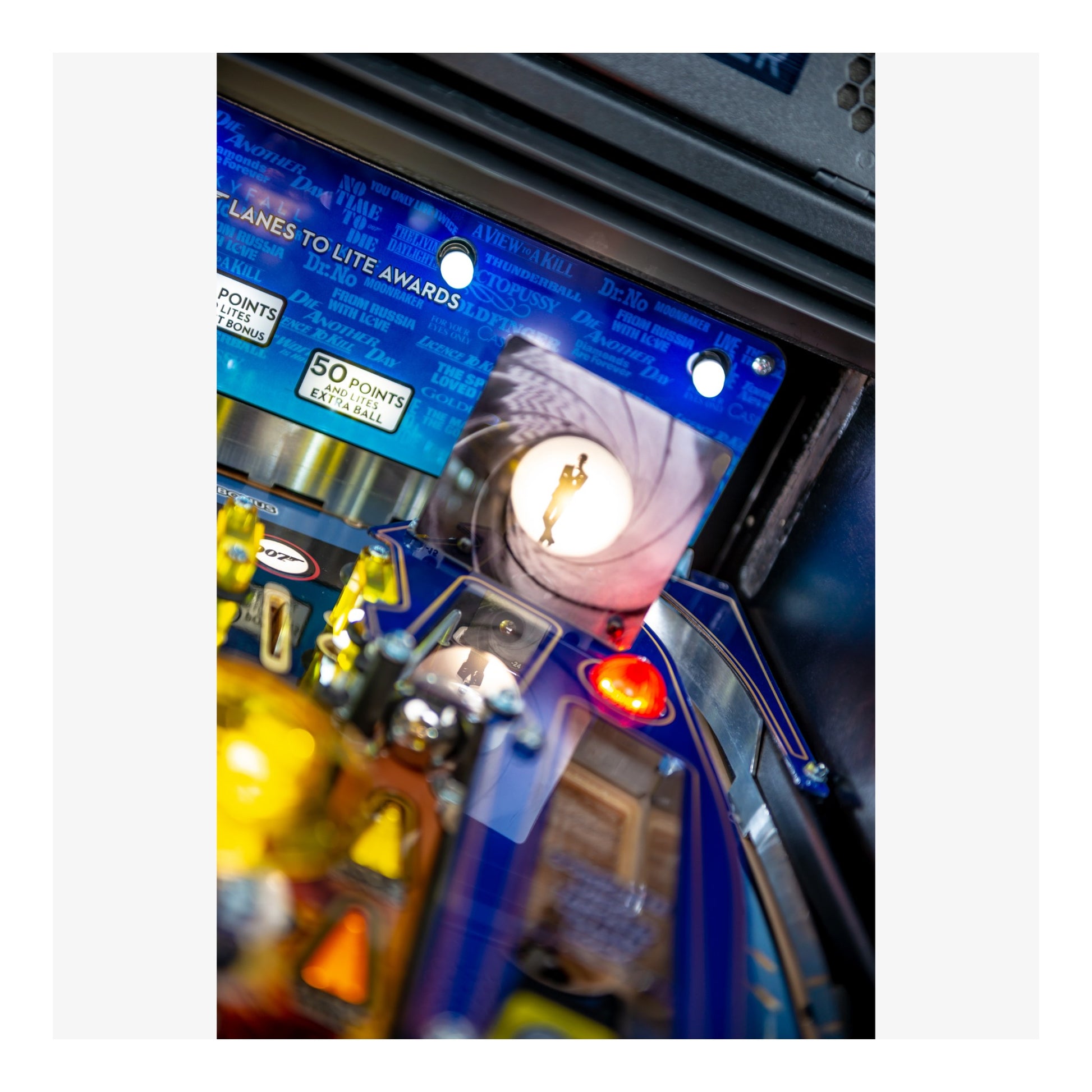 Close-up of a pinball machine with lights and components