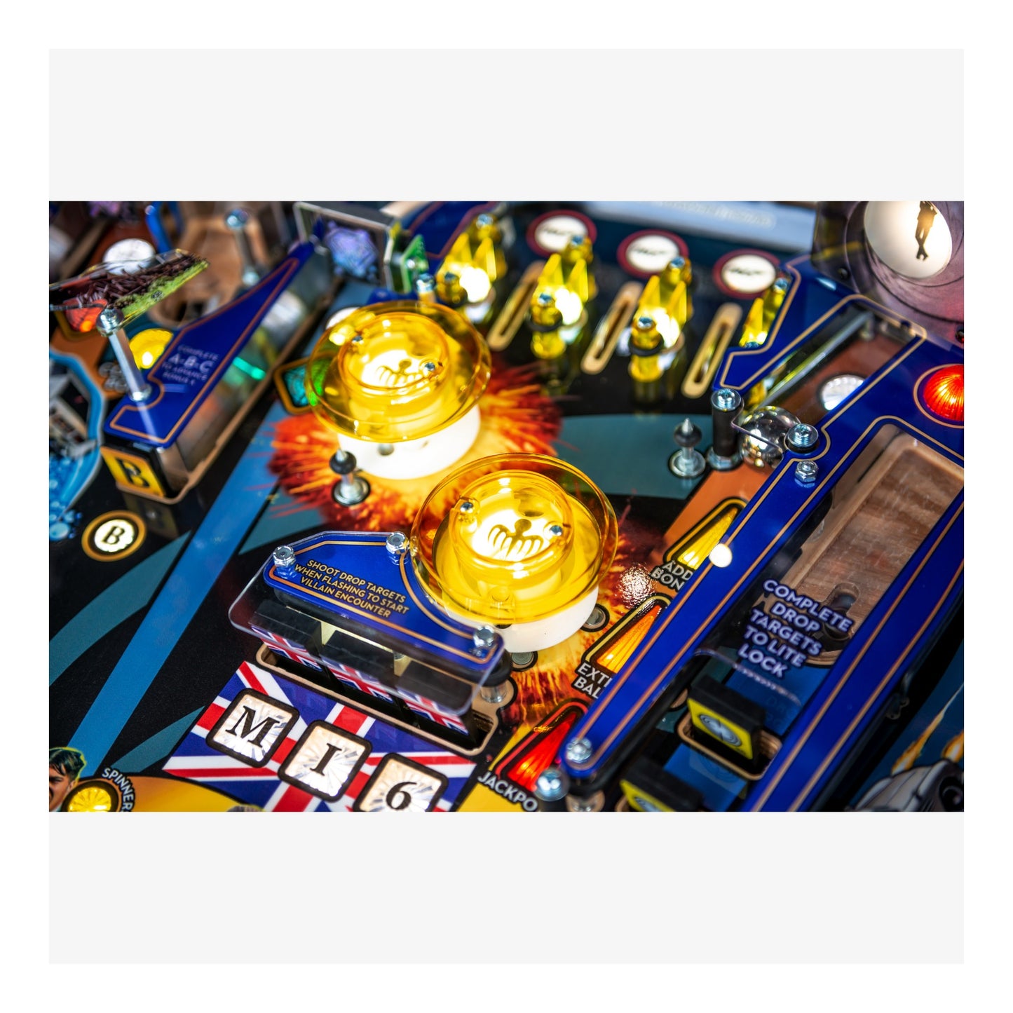 Close-up of a pinball machine with glowing lights and detailed components.