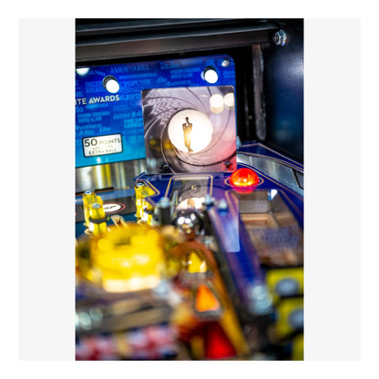 Close-up of a pinball machine with colorful playfield and vintage design elements.