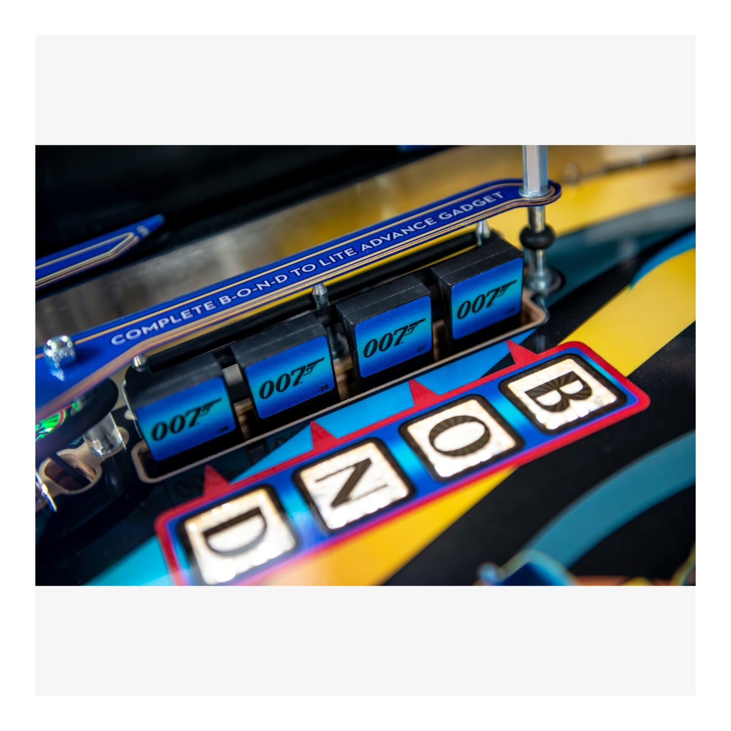 Close-up of a mechanical component with '007' branding on a colorful background