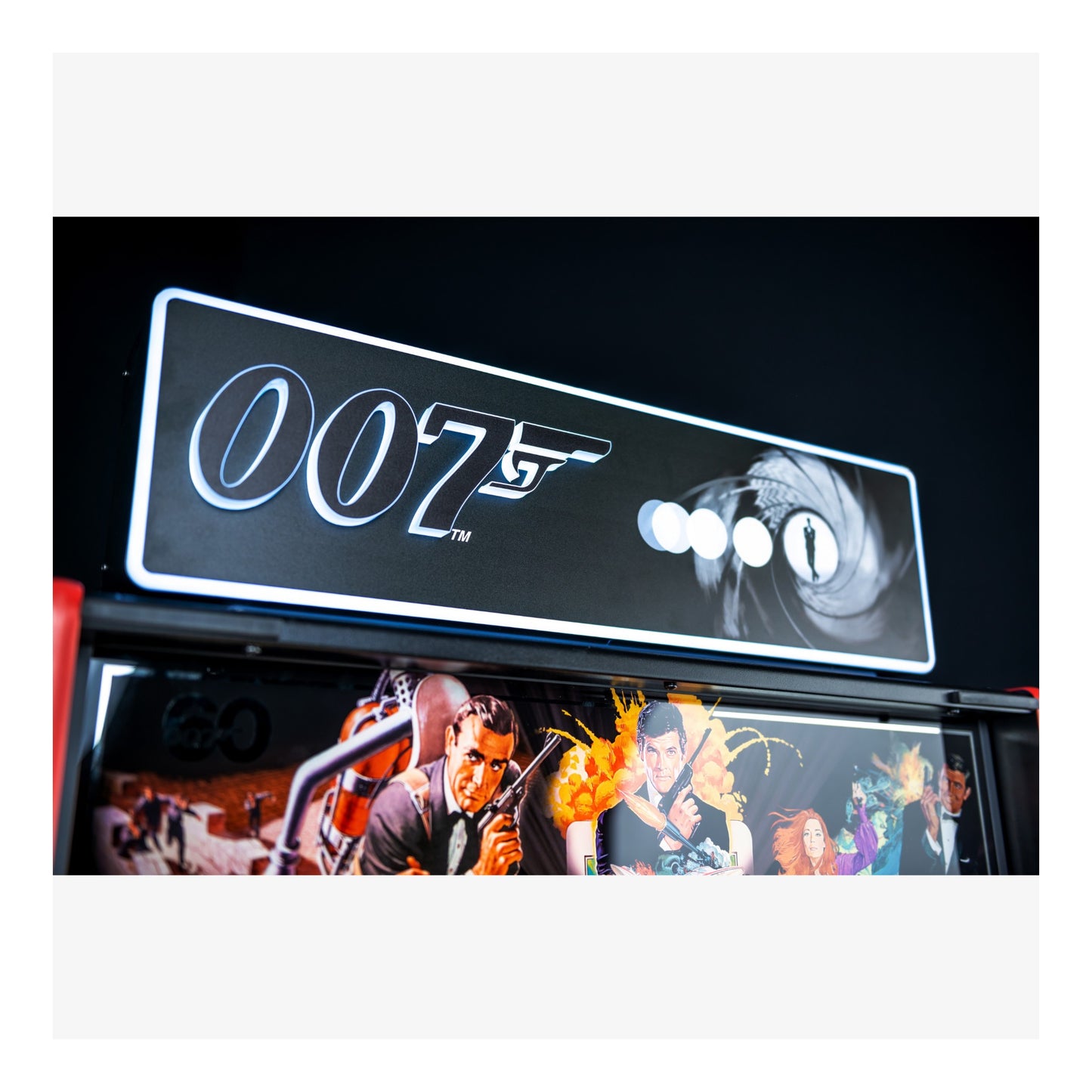 007 logo on a car's interior panel with James Bond movie scenes below.