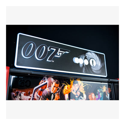 007 logo on a car's interior panel with James Bond movie scenes below.