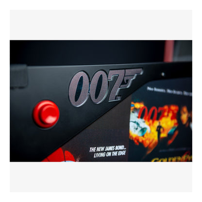 Close-up of a James Bond-themed product with '007' logo and red button.