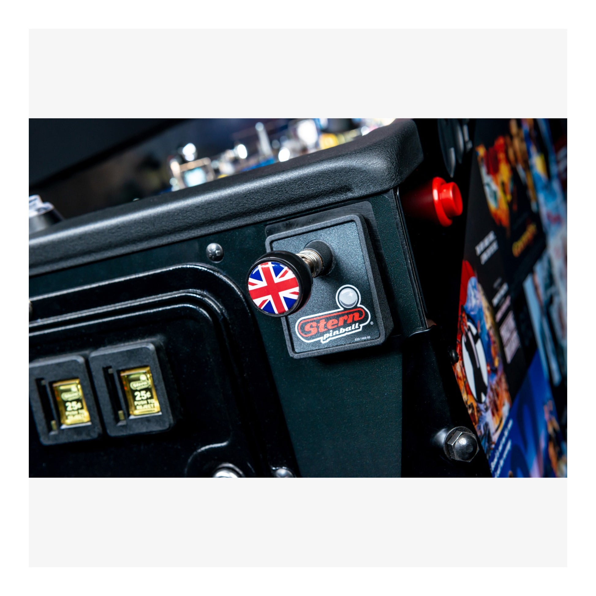 Close-up of a control panel with a British flag label and 'Stem' branding on a pinball machine.