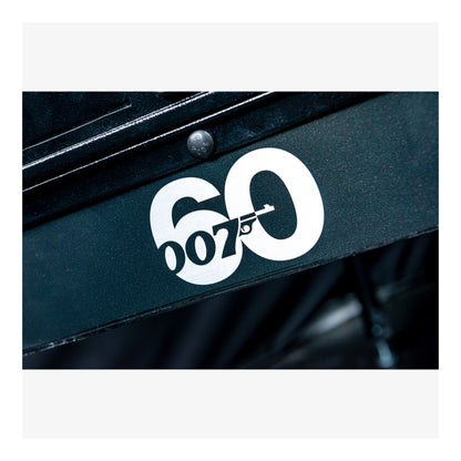 Close-up of a black surface with a white '007' logo on a white background