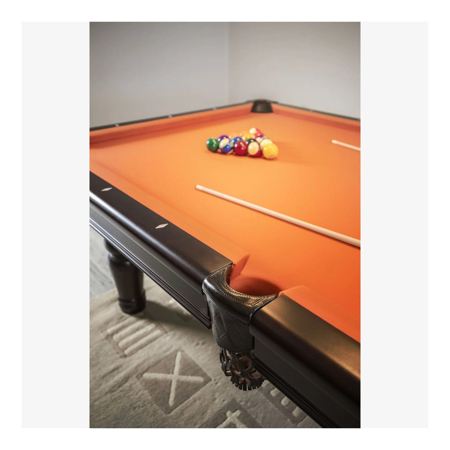 A close-up of the Aristocrat pool table's corner pocket and solid white birch rail, showcasing the wood grain.