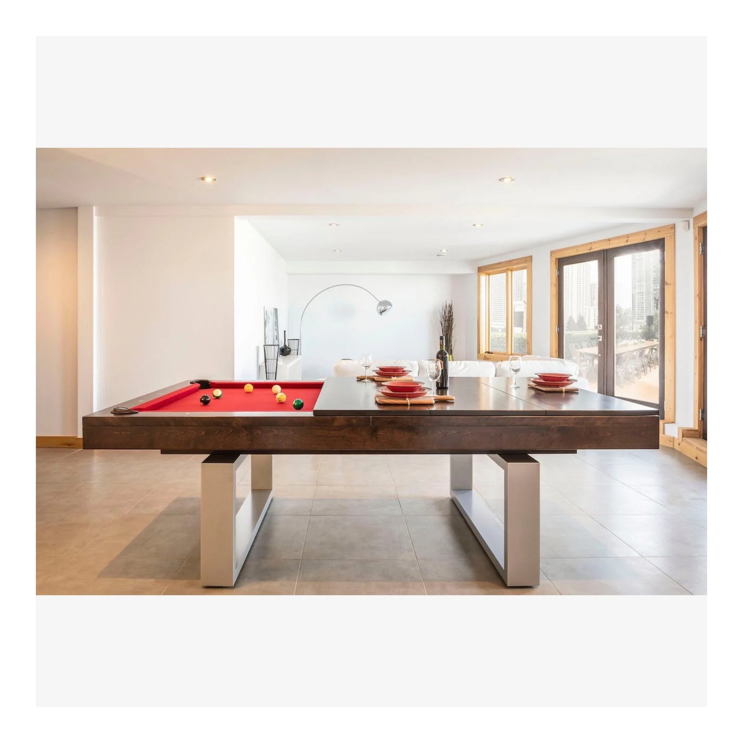 The Bridge Aluminum convertible pool table by Canada Billiard, shown with professional-grade green felt and solid wood rails in a modern dining room.