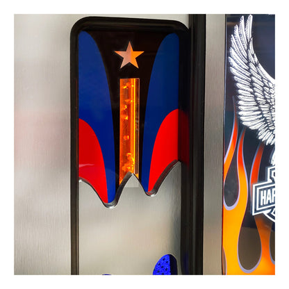 Close-up of a motorcycle with colorful design elements including a star, wings, and flames.