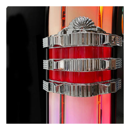 Close-up of a decorative object with red central section and silver metallic top and bottom sections on a black background.