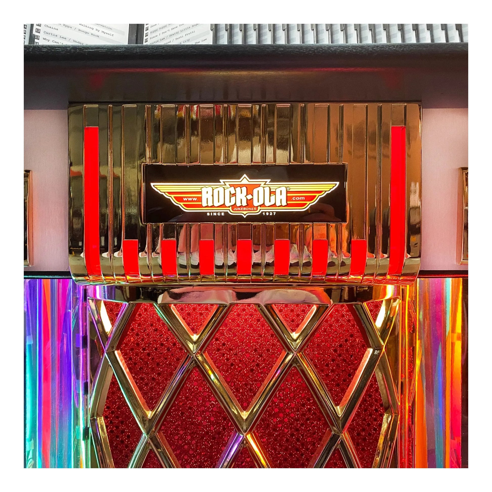 Vintage-style jukebox with 'Rock-Ola' branding in a colorful setting.