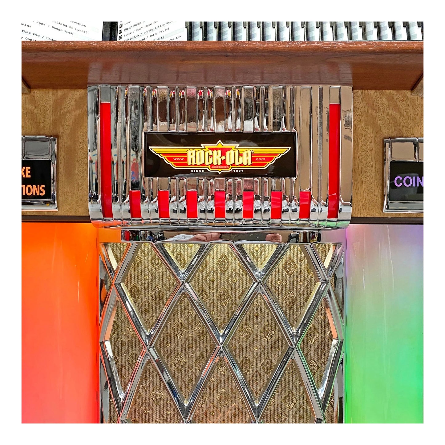 Vintage-style coin-operated machine with 'Rock-Ola' branding on a colorful background