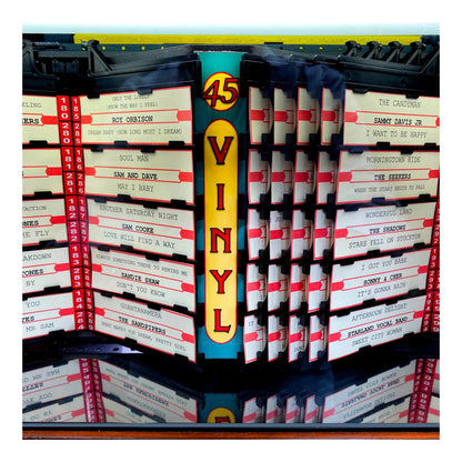 Stacks of vinyl records with a prominent '45 Vinyl' sign.