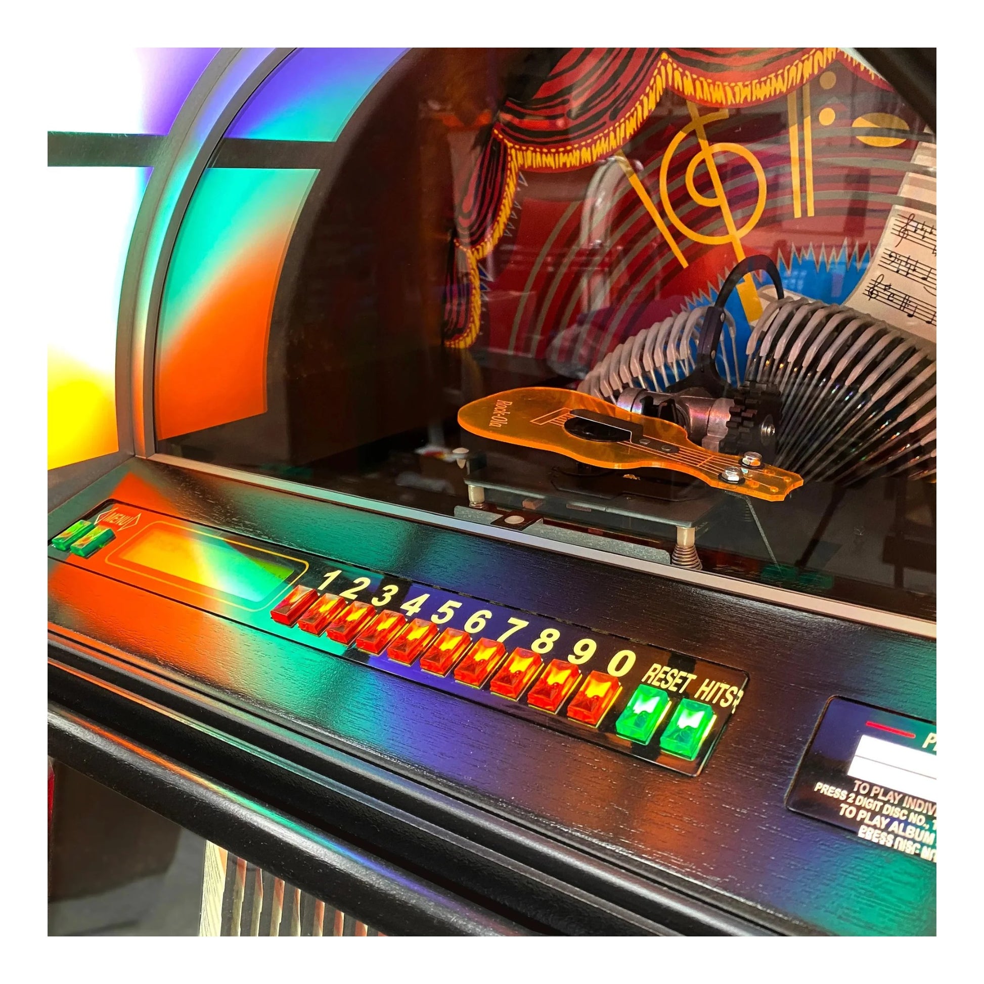 Close-up of a vintage jukebox with colorful display and control panel.