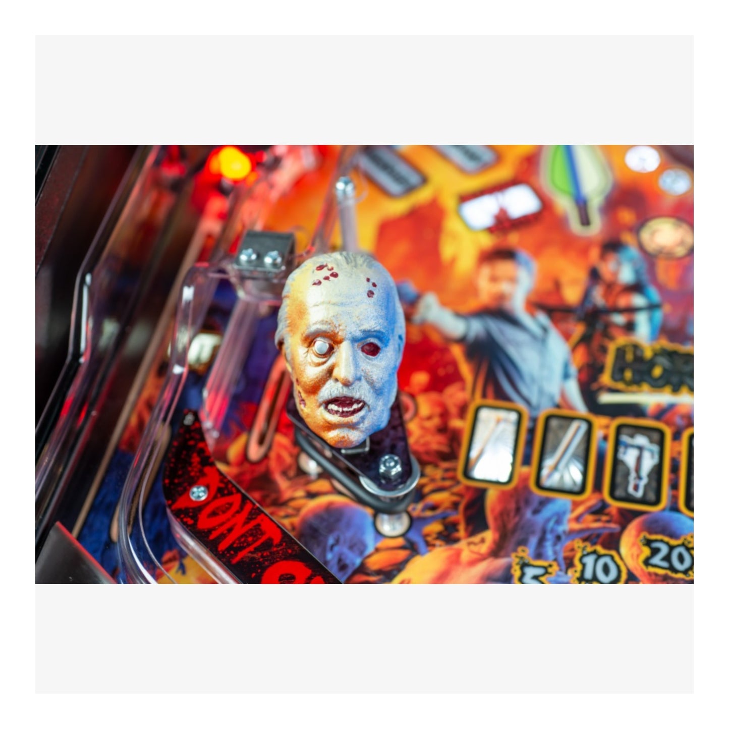 Premium Stern Pinball The Walking Dead.  Close-up of a pinball machine with a character and score display