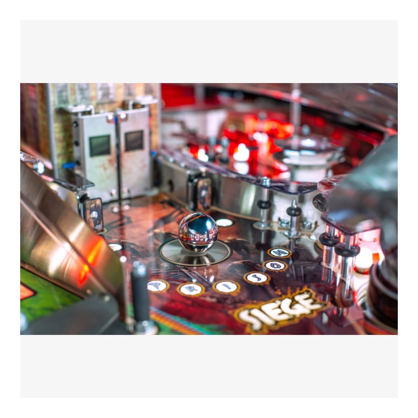 Premium Stern Pinball. Close-up of a pinball machine with a glass ball on the playing field.