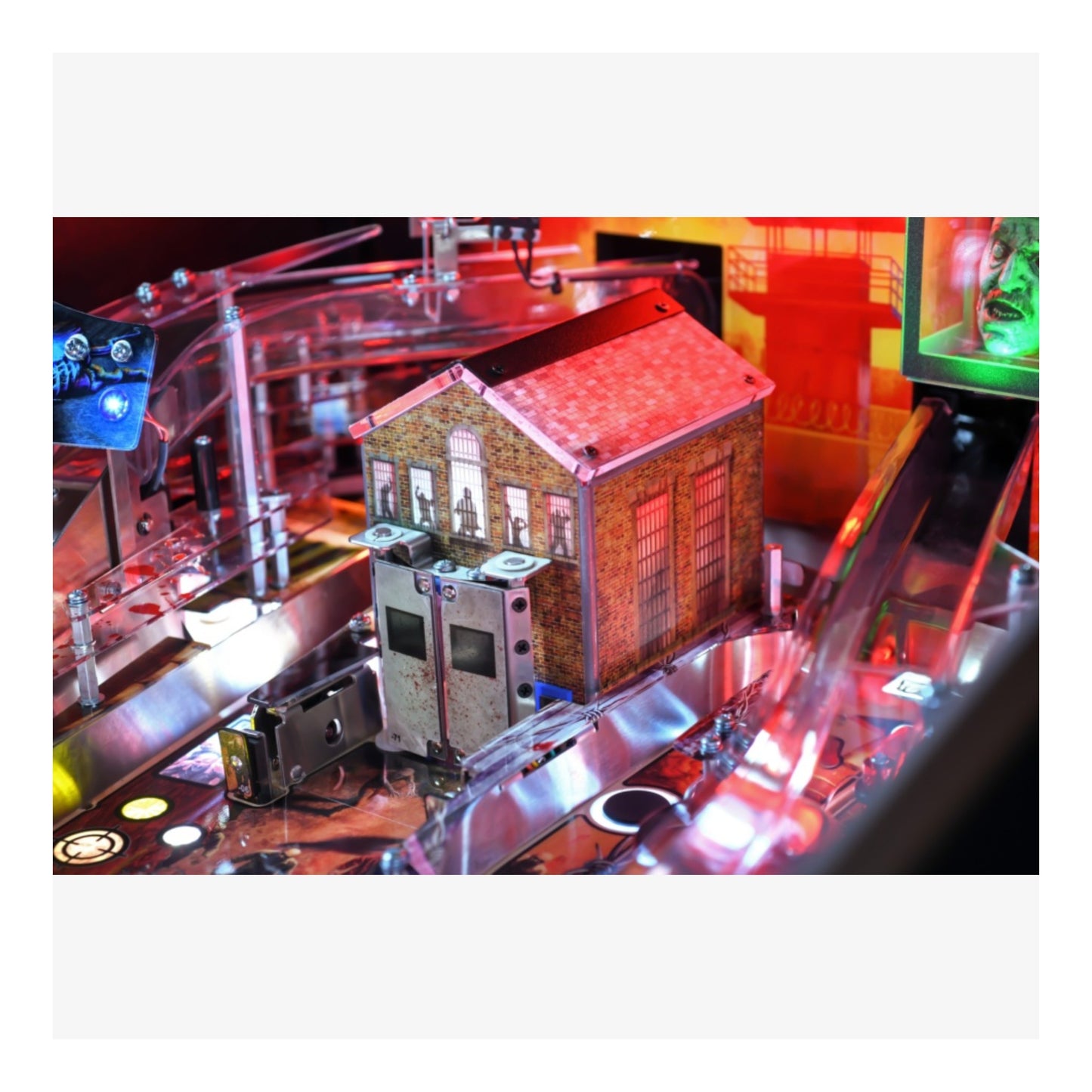 Premium Stern Pinball The Walking Dead.  Close-up of a pinball machine with a detailed house-like structure on the playfield.
