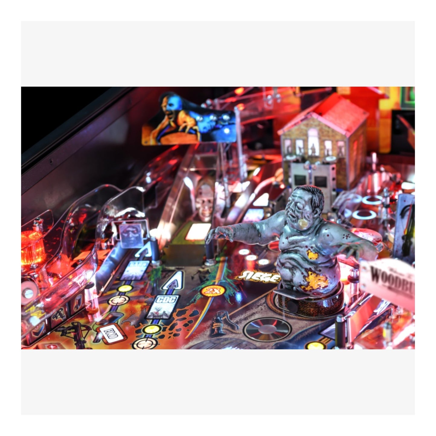 Premium Stern Pinball The Walking Dead.  Close-up of a pinball machine with various game elements and lighting effects.