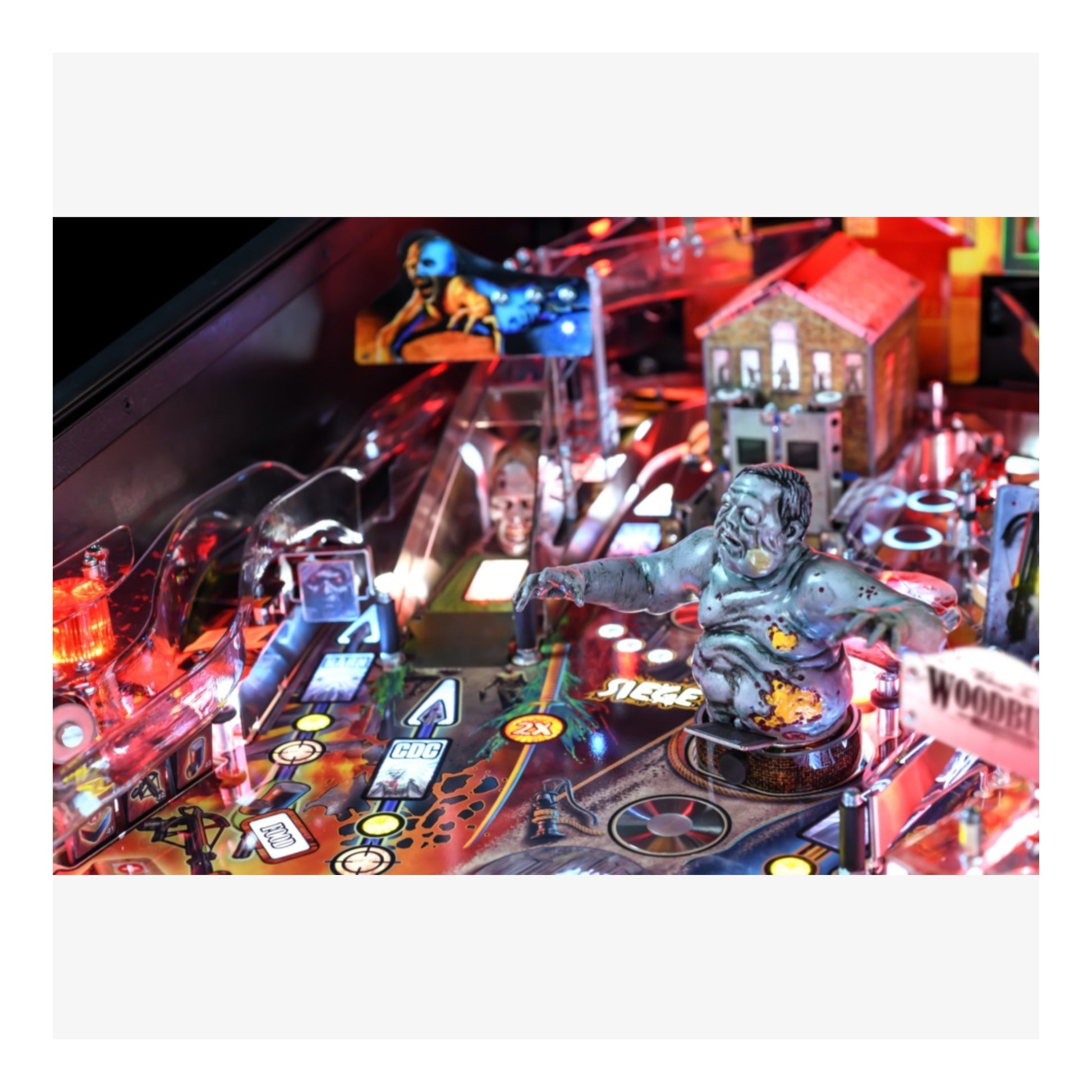Premium Stern Pinball The Walking Dead.  Close-up of a pinball machine with various game elements and lighting effects.