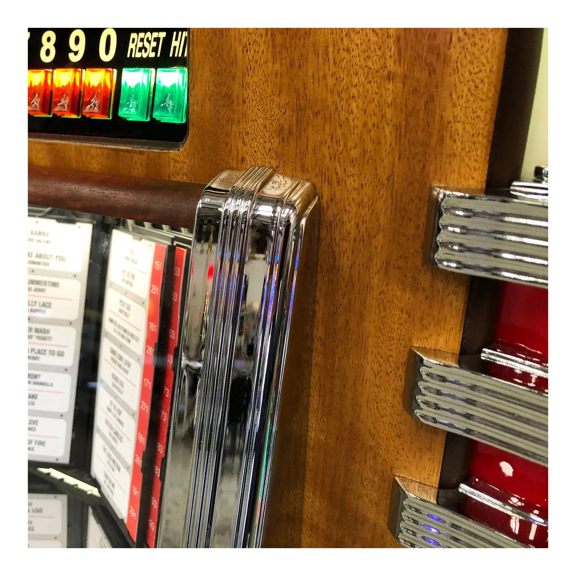 Close-up of a vintage jukebox with wooden finish and metallic accents.
