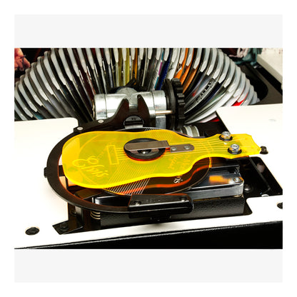 Close-up of a hard drive with a yellow thermal pad on a white background
