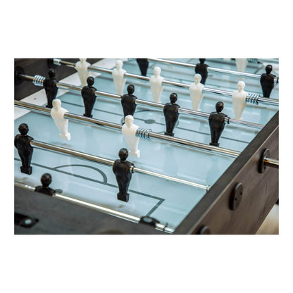 Close up of black and white players on cool gray tempered glass playfield