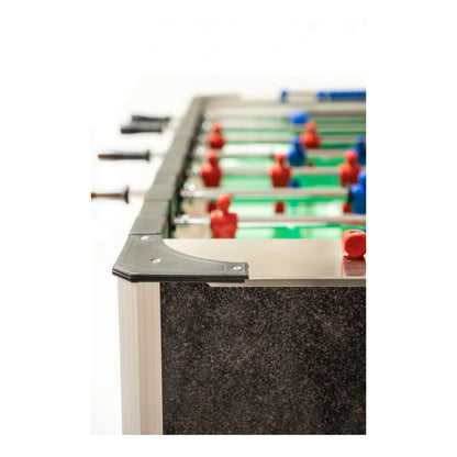 Close-up of a foosball table with red and blue player figures on a white background