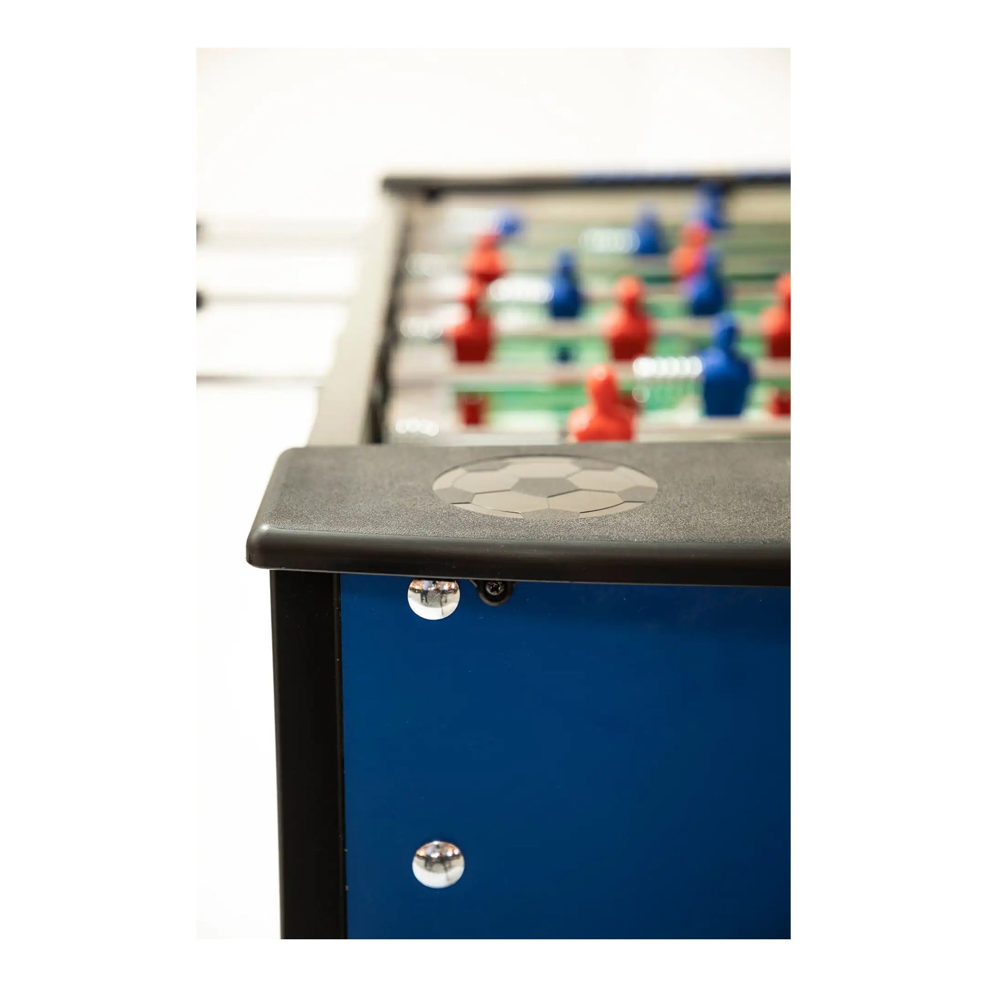 Close-up of a foosball table with players and a ball on a white background