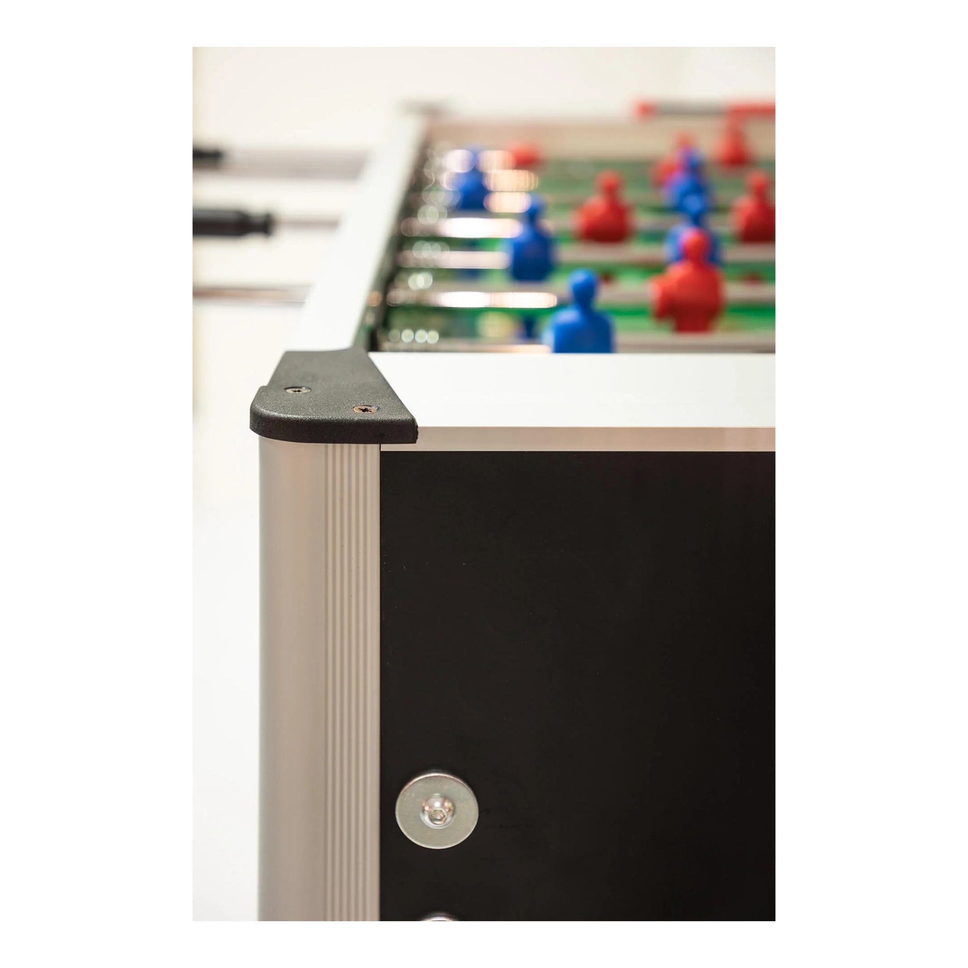 Close-up of a foosball table with players on the playing surface.