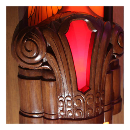Close-up of a wooden lamp with red glass shade