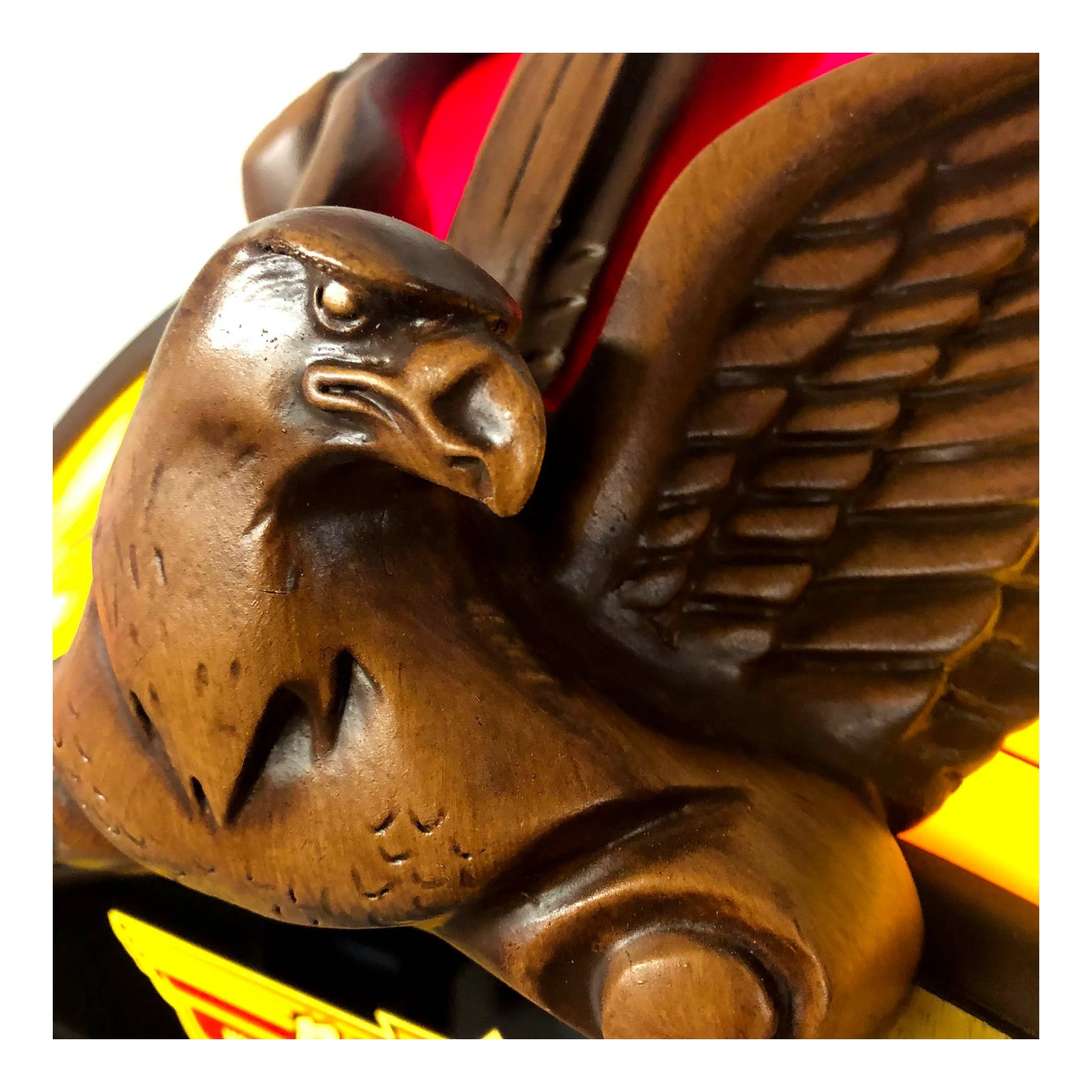 Wooden eagle sculpture with detailed carving on a white background