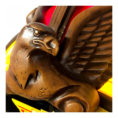 Wooden eagle sculpture with detailed carving on a white background