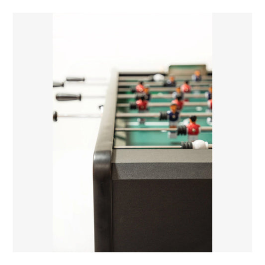 A close-up of the Ideal Worldcup foosball table's side, showing the black handles on the chrome telescopic rods and the manual score keeper.