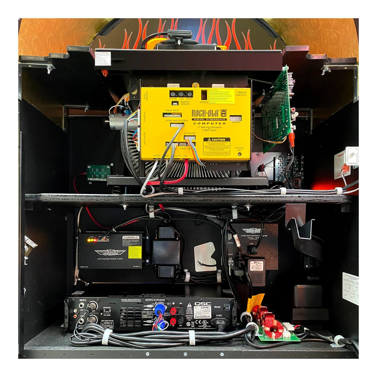 Technical setup with a yellow component, batteries, and wiring on a black background