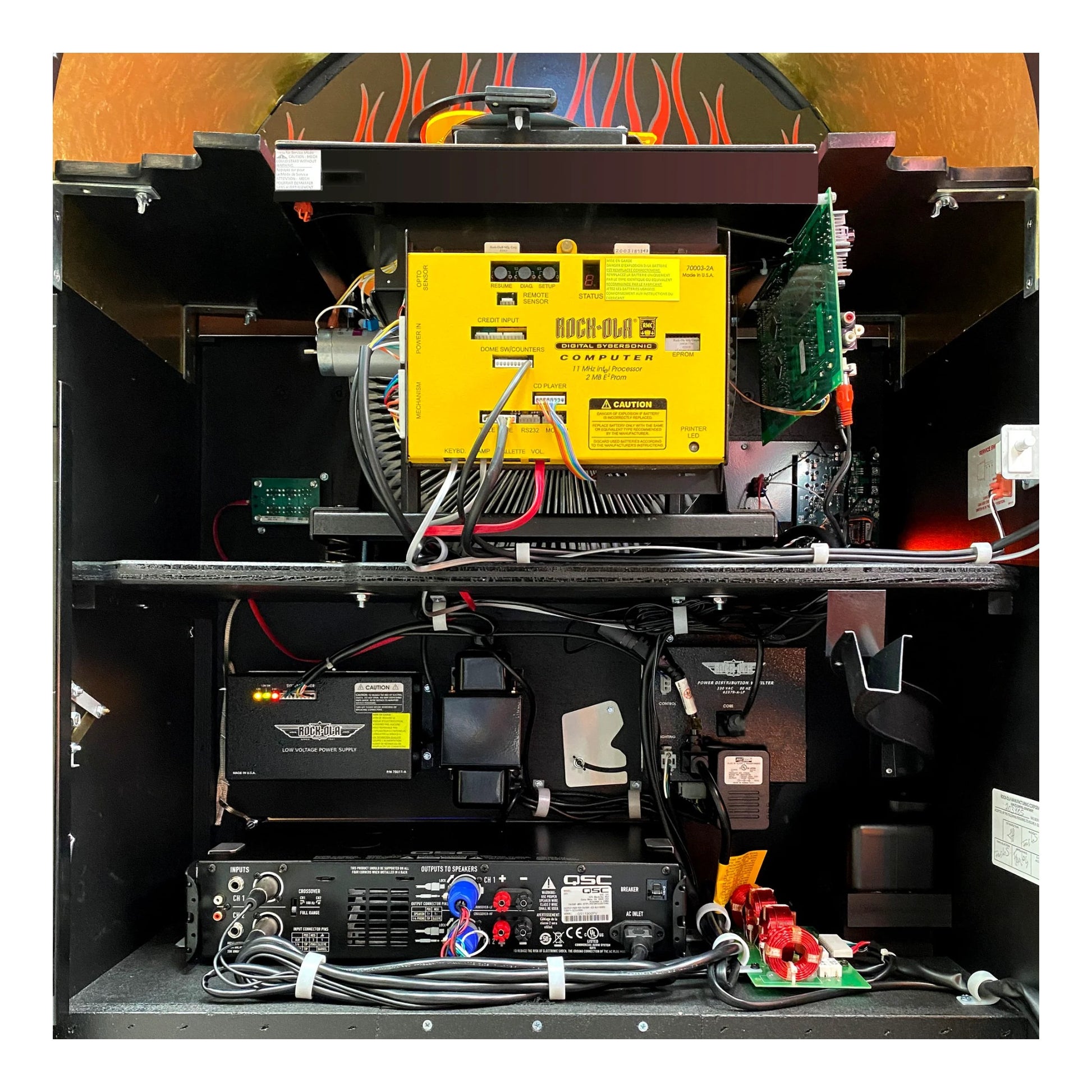 Technical setup with a yellow component, batteries, and wiring on a black background