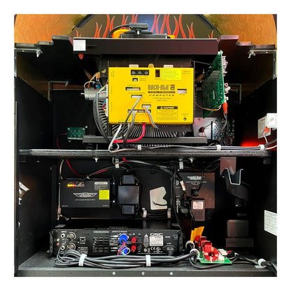 Technical setup with a yellow component, batteries, and wiring on a black background